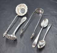 A pair of Victorian Irish silver fiddle pattern sugar tongs, having a heraldic crest to the end,