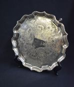 An Elkington & Co silver plated salver, of circular form having a Chippendale style rim with central