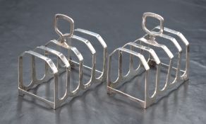 A pair of George VI silver toast racks, of traditional form with pierced handles, marks for