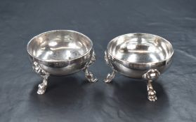 A pair of Georgian silver salts, of circular form having rubbed coat-of-arms to the body, raised