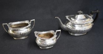 A Victorian silver three piece tea set, comprising a tea pot, sugar and cream, each of oval half-