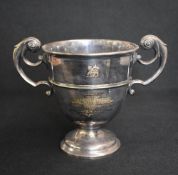 An early Edwardian silver trophy, of traditional form having opposing scroll handles, with