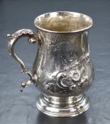 A Victorian silver tankard, of traditional bulbous form having a slightly flared rim, scroll handle,