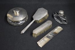 A George VI silver mounted vanity set, comprising a hair brush, a comb and a mirror, having a