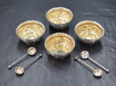 A cased set of four Victorian silver salts, of circular form having crimped rims and embossed scroll
