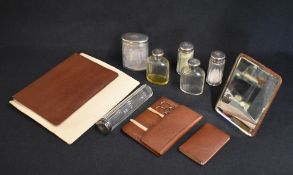 An early 20th century cased travelling set, the brown leather case with protective cover