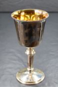 A cased Elizabeth II silver cup, of traditional form having a slightly flared rim, gilted interior