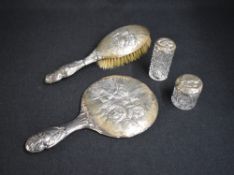 An Edwardian silver mounted vanity set, comprising a mirror, hair brush and two silver capped cut