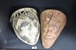 An Art Nouveau design ceramic wall pocket having pierced top, below decorated with female bust