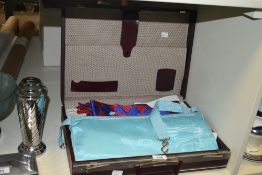 A leather case containing various Masonic regalic, to include two Mason aprons, a sash, a United