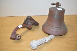 A bronze bell having original wall bracket, inscribed 'Metal Ex H.M.S Rodney Dismantled