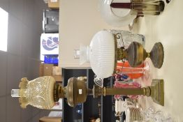 A 19th century brass oil lamp having corinthiam column, glass chimney and floral shade, h80cm,