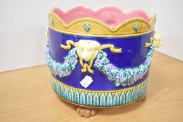 A early 20th century Majolica jardiniere decorated with lion heads and claw feet, h20cm