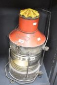 A 20th century galvanised navigation ship's lantern with 360 degree glass fresnel, N.M.V mark to