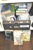 A box containing various novels, to include Robinson Crusoe, The Sly Fox and the Little Red Hen, The