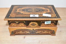 An ornate inlaid wooden musical jewellery box, containing a small collection of costume jewellery