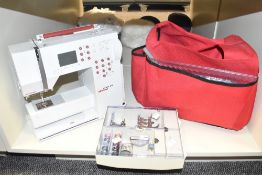 A Bernia Activa 240 sewing machine complete with accessories and bag.
