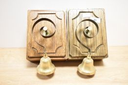 A pair of Byron brass door bells in a traditional square oak case, h20cm