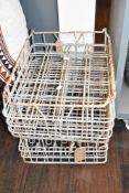 A pair of vintage milk bottle crates, L45cm x W36cm