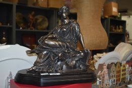A large reproduction cast resin classical female on black plinth, measuring 29cm tall.