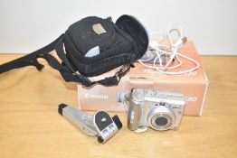 A Canon PowerShot A530 Digital Camera with hama stand and charging cable
