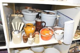 A Le Creuset volcanic orange oval lidded casserole dish, L26cm, sold together with 5 side knives,