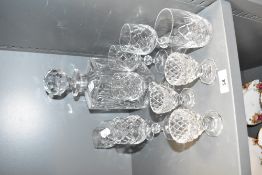A cut glass decanter having faceted ball stopper, h25cm, sold together with 10 liqueur glasses, ( 11