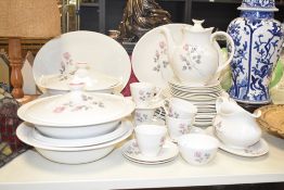 A Royal Doulton Pillar Rose pattern dinner service decorated with floral patterns on a ice white