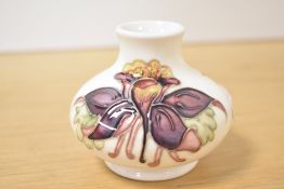 A Moorcroft vase of baluster form decorated with columbine on a cream glaze ground, h7.5cm