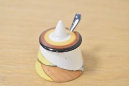 A Clarice Cliff Bizarre ware mustard pot with silver spoon, h5.5cm