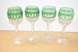 A set of four Waterford 'Clarendon' pattern cut crystal wine glasses having green colour bowl and