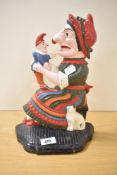 A late 19th / early 20th century Punch and Judy cast iron door porter, hand coloured, makers mark to