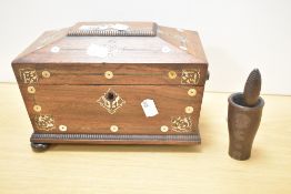 A 19th century rosewood tea caddy of sarcophagus form, supported on bun feet, decorated with pearl