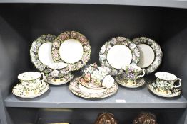 A pair of Royal Albert Mayflower pattern cup and saucers, decorated with pink and green foliage on a