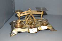 An early 20th century cast brass postal weight scales with weights, sold with sovereign scale, 21cm