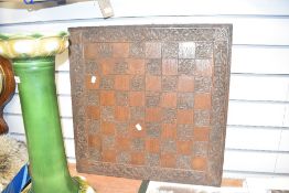 A early 20th century oak chess board hand carved with floral patterns, w60cm x h60cm