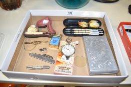 A box containing a BMC Drivers Club pin badge, a yellow metal cigarette lighter, a cigarette case,