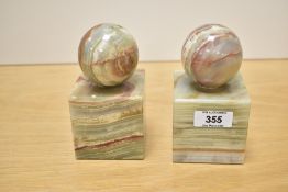 A pair of square green onyx book ends having spherical surmounts, h12.5cm