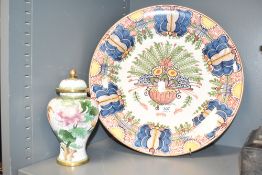 A Royal Tichelear ceramic chargerr decorated with multicolour foliage on a white ground, pattern