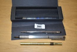 A boxed Lamy Logo converter/ cartridge fill fountain pen with a Cross ballpoint with boxed refill.
