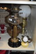 A vintage oil lamp having glass bowl and brass column complete with glass flute, measuring 66cm