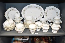 A Paragon Glendale Regid pattern dinner service, decorated with foliage on an ice white ground, to