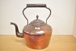 A 19th century large copper tea pot with shaped spout and handle, h35cm