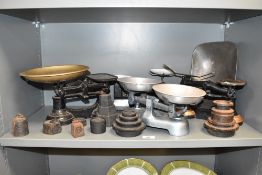 A group of cast iron weighing scales, ( 4 ), to include weights.