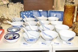 A group of 14 soup bowls decorated in the Chinese style having blue and white fish and foliage