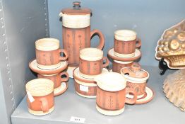 A G. Fox studio pottery tea service decorated with floral patterns on a burnt red ground, makers