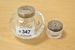 An early 20th century controlled bubble clear glass inkwell, h5.5cm, sold together with a small