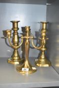 A three arm brass candelabra, h24cm, sold together with a pair of brass candlesticks, ( 3 ).