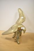 A large vintage brass eagle sculpture perched on a tree branch, wingspan 41cm