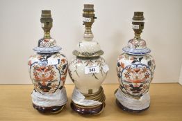 A pair of porcelain baluster table lamps in the Chinese taste, decorated with floral and key